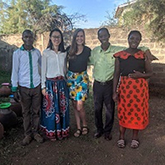 Sara Stokes stands with local health workers she worked with in Kisumu, Kenya, posing for a picture.