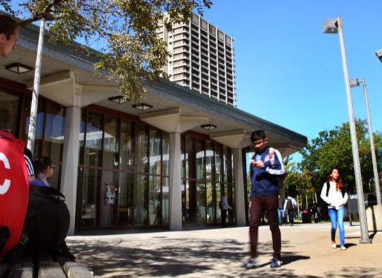 Students walk across UIC's quad on a sunny day.