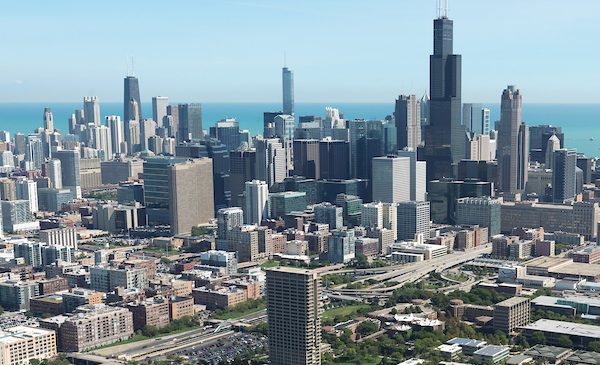 An aerial view of the Chicago skyline, with UIC's University Hall in the foreground.