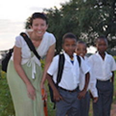 Jessica Ruggiero poses for a photo with three young boys in Botswana.