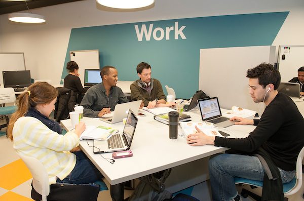 Students collaborate in a shared work space on UIC's campus.