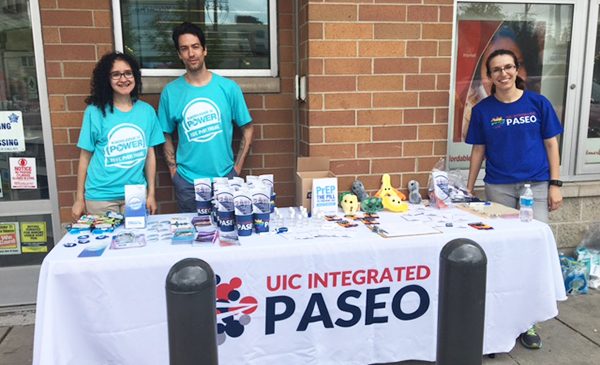 Students in the BA Public Health program work a table at a Chicago event, providing information on sexual health.