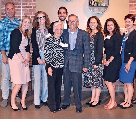 Lanny and Terry Passaro pose for a photo with student recipients of the scholarship they started.