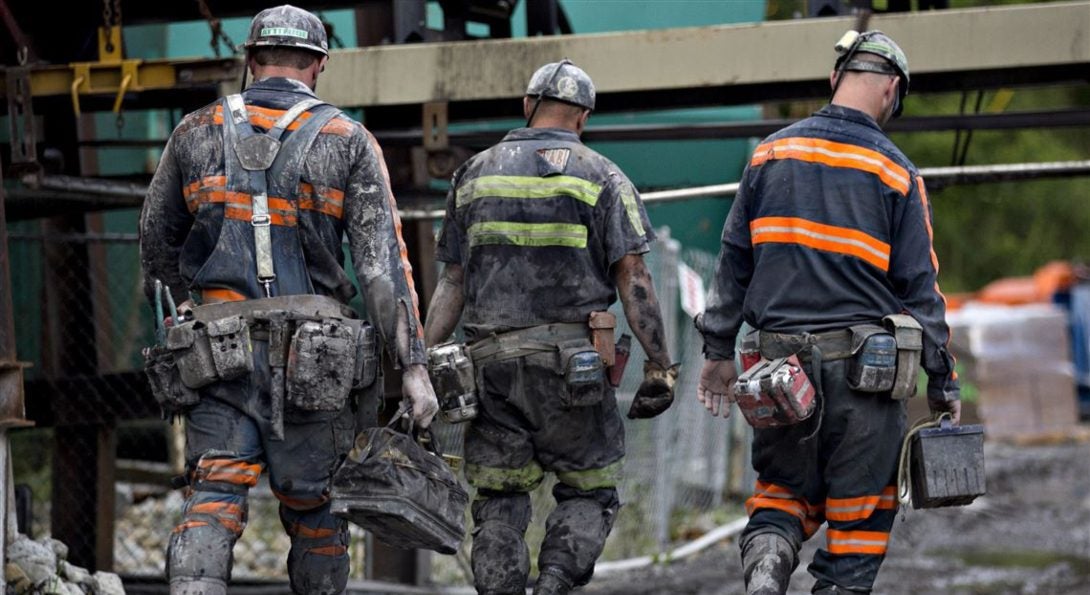 Coal miners walk together following a shift of work.