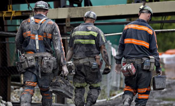 Coal miners walk together after a work shift.