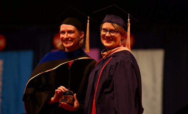 A student receives an award at the 2018 Commencement ceremony.