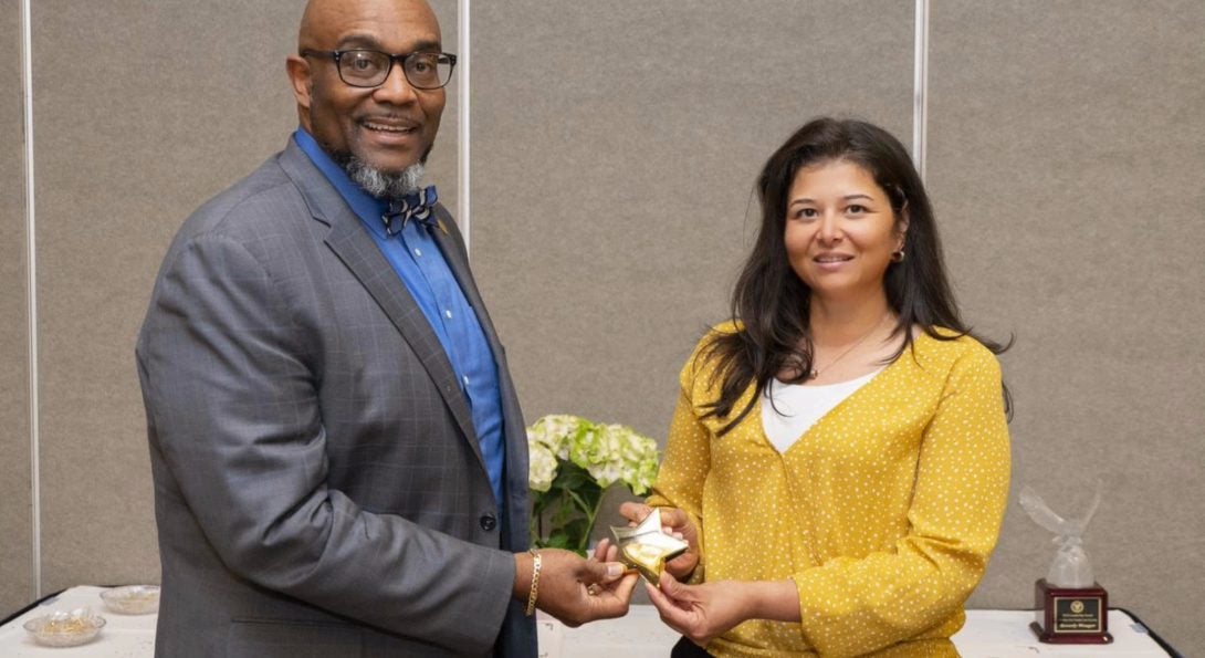 Nytzia Licona accepts her volunteer award at an awards ceremony.