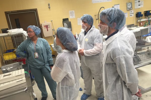 tours in personal protective gear at hospital