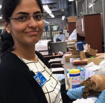 Sampada Mudgalkar poses for a picture while holding a human skull that was quarantined at O'Hare from a passenger's baggage.
                  