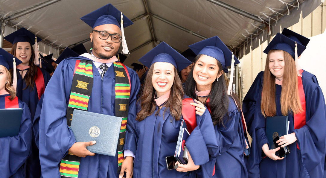 Graduates pose for a photo outside the UIC Pavilion at the conclusion of the Commencement ceremony.