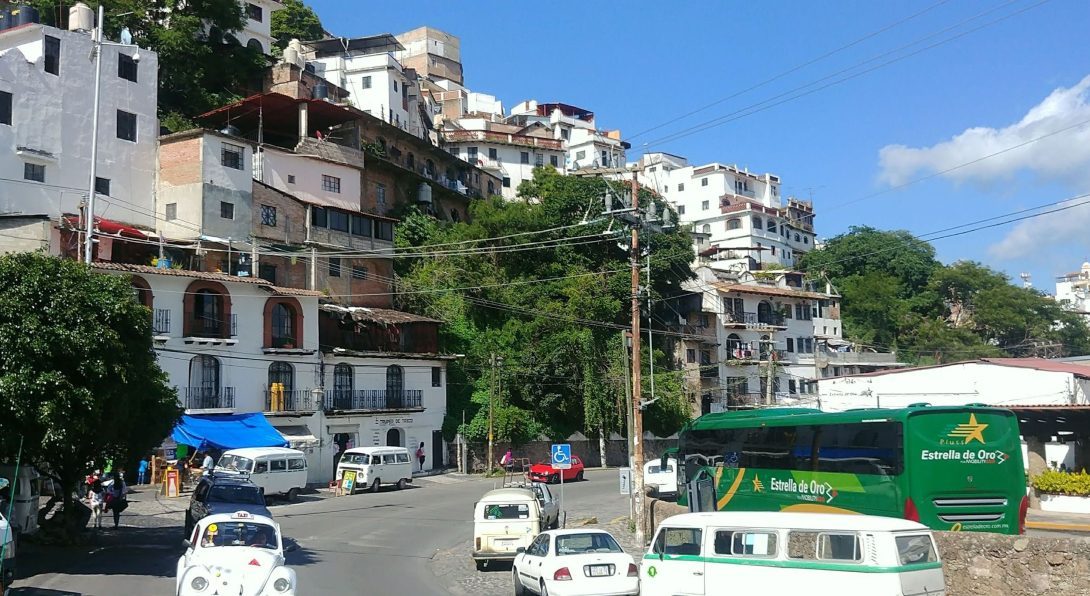 A street with car traffic and buildings along the side, in Cuernavaca, Mexico.