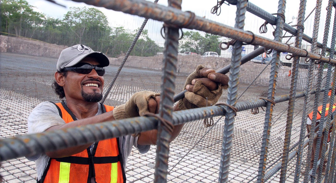 A worker assembles rebar at a water treatment plant.