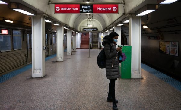 A solitary rider wears a mask while waiting for a CTA train at an underground station in Chicago.