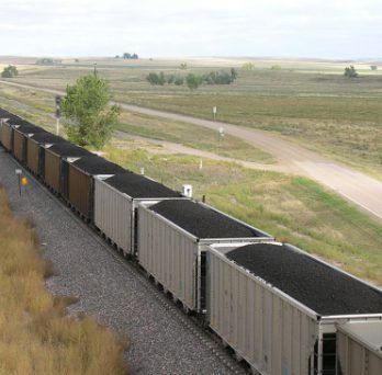 A coal train travels across a valley in Wyoming. 