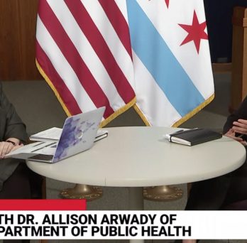 A screenshot of the video broadcast of the Chicago Department of Public Health's daily COVID-19 update, with Dr. Allison Arwady and SPH's Dr. Janet Lin seated at a table discussing issues related to the outbreak.
                  
