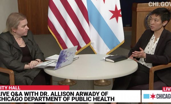 A screenshot of the video broadcast of the Chicago Department of Public Health's daily COVID-19 update, with Dr. Allison Arwady and SPH's Dr. Janet Lin seated at a table discussing issues related to the outbreak.