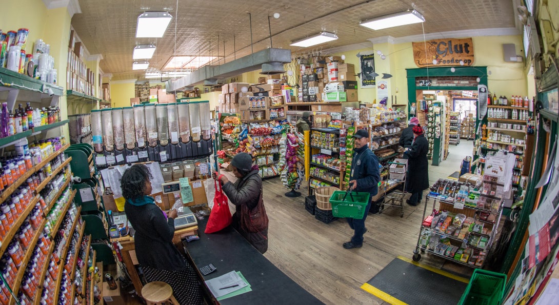 A grocery store in Seattle, with a cashier checking out a customer's items.