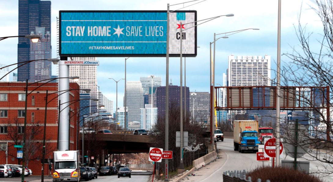 A Chicago billboard alongside Interstate 90/94 states: Stay Home, Save Lives.