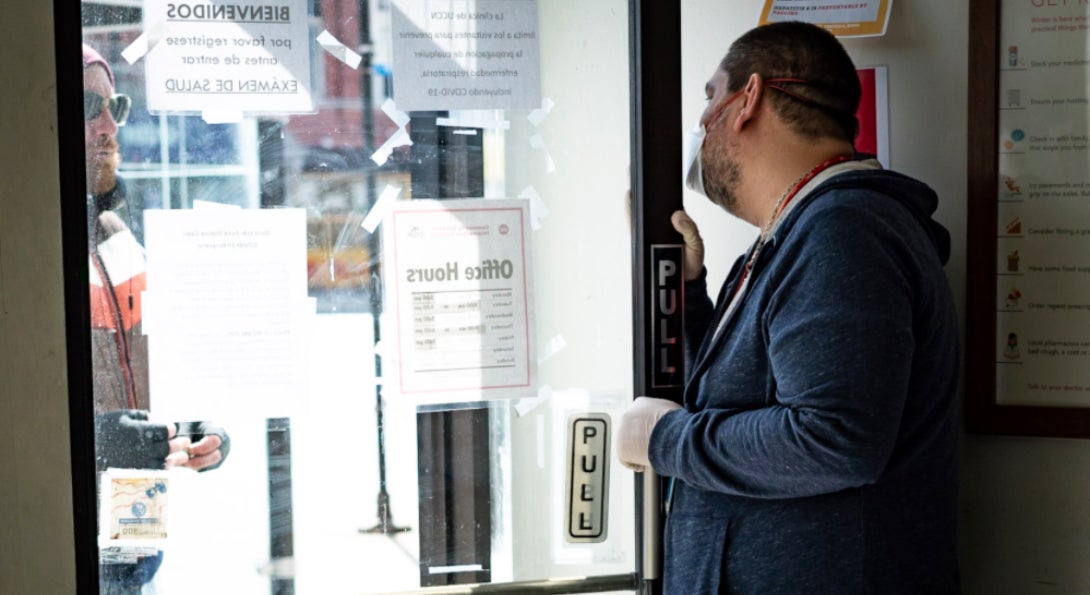 A COIP employee greets a client at a field site in Chicago's Austin neighborhood. 