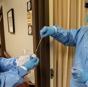 A medic with the Massachusetts National Guard takes a nasal swab that will be used to test for COVID-19 with a resident of a nursing home in Littleton, Mass.
                  