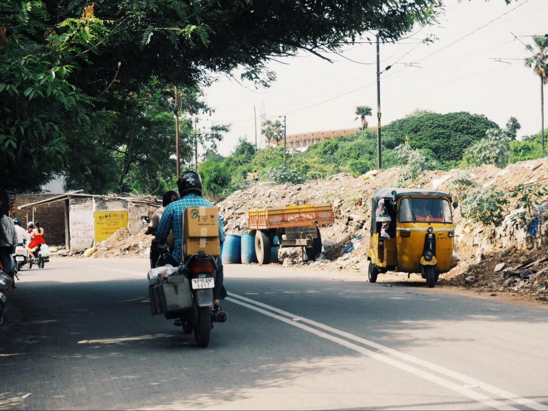 Photo 1. scenery in front of the host organization in the suburb of Hyderabad. Motorcycles and auto-rickshaws are popular transportation of the locals.