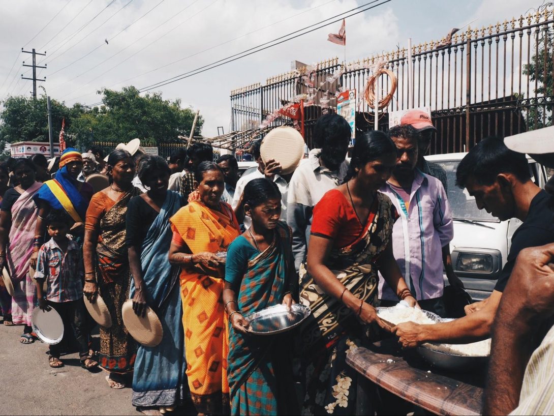 photo 3. People line up to receive the free lunch (rice) from the Sani Welfare Foundation on a street next to the hospital.