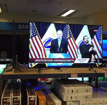 Flatscreen TVs for sale in a Cambridge, Massachusetts electronics store display Gov. Charlie Baker discussing the COVID-19 pandemic.
                  