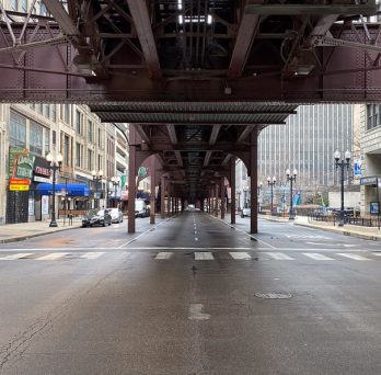 Wabash Avenue in Chicago, under the L tracks, is devoid of traffic during COVID-19 shelter-in-place orders.
                  