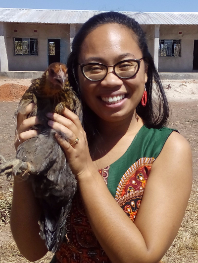 Sarah Lomahan poses for a picture holding a chicken while working for the Peace Corps in Zambia.