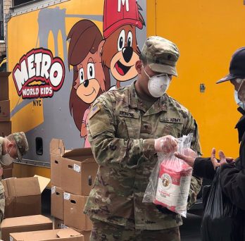 Members of the New York National Guard help distribute food to residents during the COVID-19 pandemic.
                  