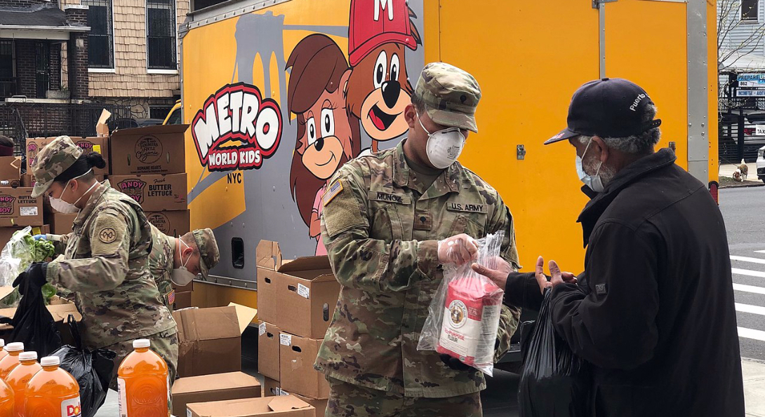 Members of the New York National Guard help distribute food to residents during the COVID-19 pandemic.