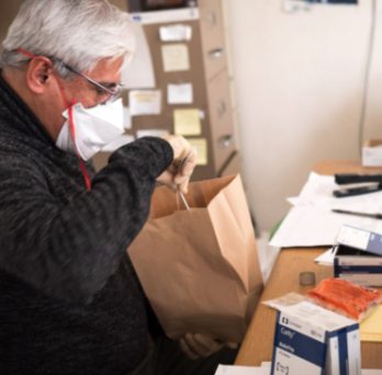 COIP director Dave Jimenez prepares a bag of supplies for a needle exchange client. 