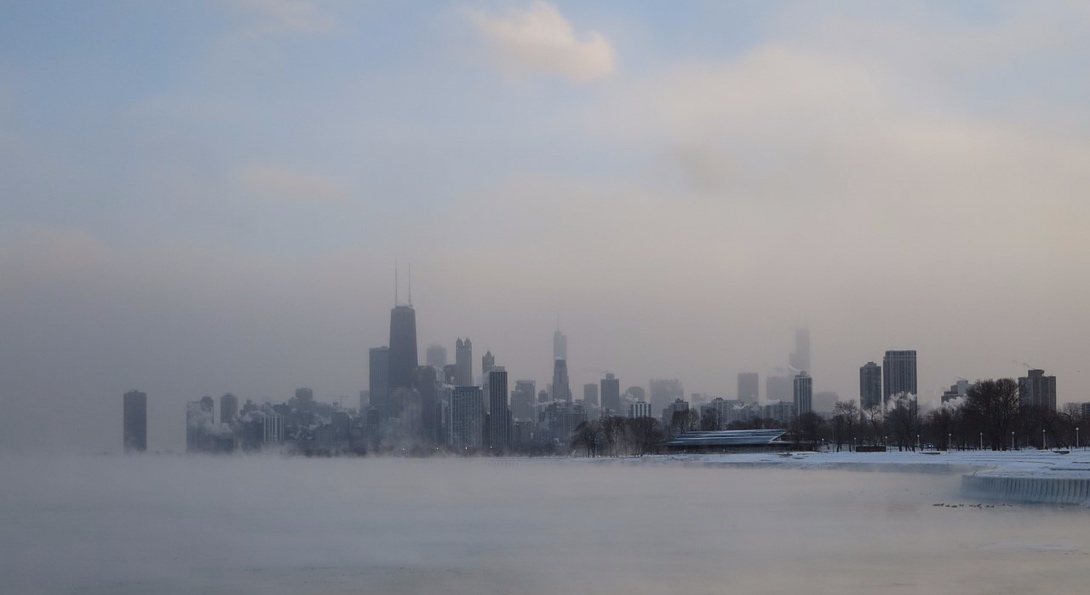 Fog rises from a frozen Lake Michigan and envelopes the Chicago Loop during the 2014 polar vortex.