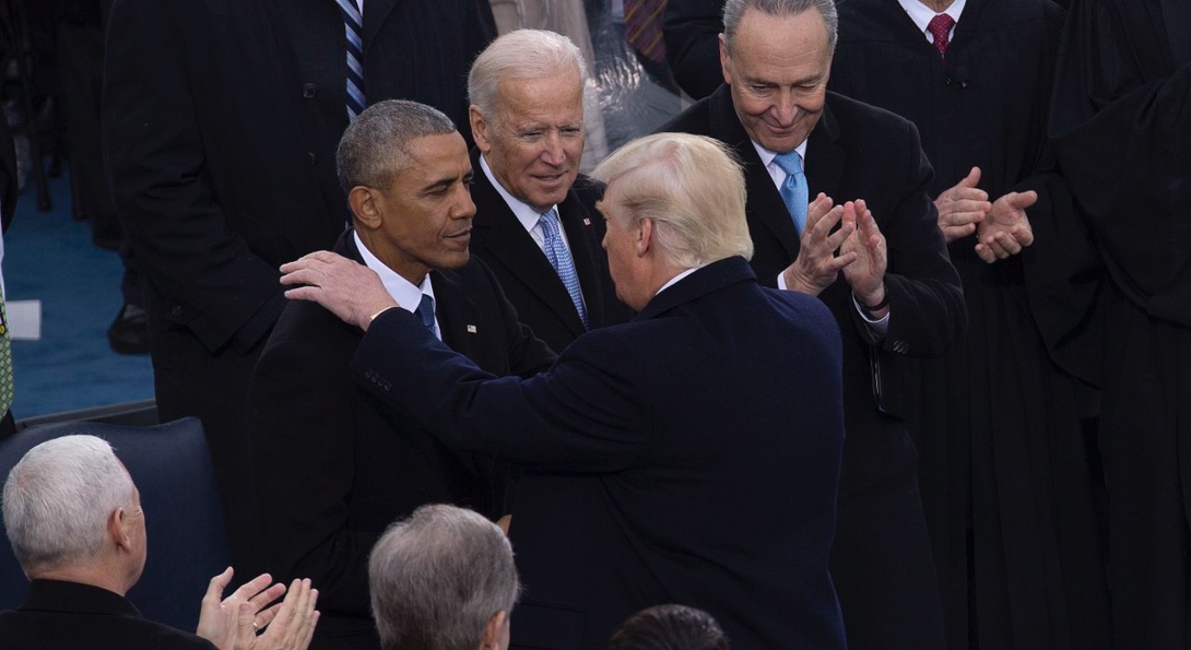 President Donald Trump shares a moment with outgoing President Barack Obama and Vice President Joe Biden at the 2016 inauguration.
