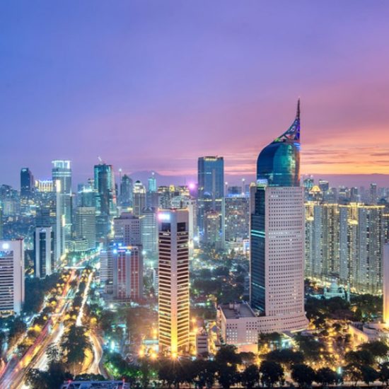 An aerial view of the skyline of Jakarta at night.