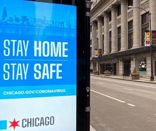 A sign on an empty street in the Loop in Chicago states 