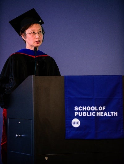 An Li speaks from a podium at the investiture ceremony.