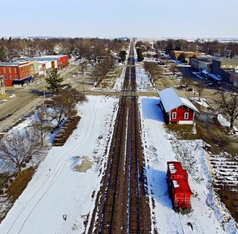 An aerial view of the town of Bushnell, Illinois, bisected by railroad tracks.
                  