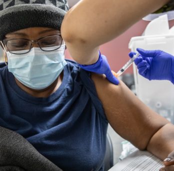 An resident of the Englewood neighborhood in Chicago receives a COVID-19 vaccine at a pop-up clinic established by UIC.
                  