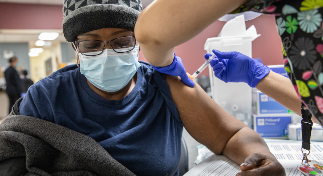 An resident of the Englewood neighborhood in Chicago receives a COVID-19 vaccine at a pop-up clinic established by UIC.
