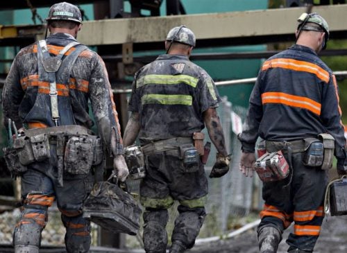 Coal miners walk together following a work shift.