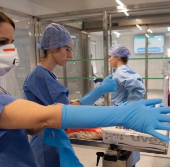 Medical professionals don personal protective equipment before meeting with COVID-19 patients at a hospital in Barcelona, Spain.
                  