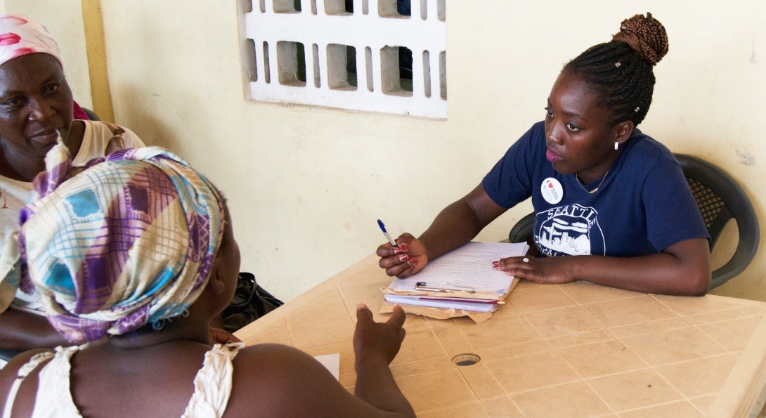 SPH student Mary Otoo conducts an interview with a woman in Kisumu, Kenya.