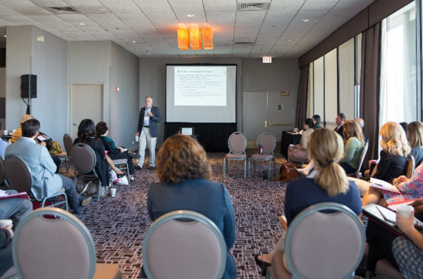 Interior of room with a lecturer and listening audience