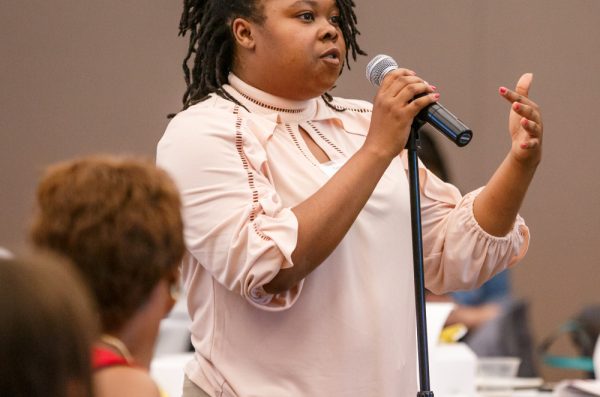 A student asks a question of a panel discussion at the 2019 Minority Health Conference.
