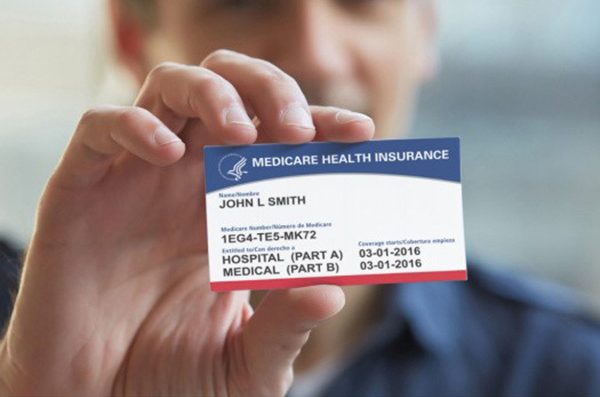 closeup of a hand holding a Medicare health insurance card