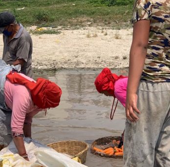 Residents of Kathmandu wash vegetables in raw river water.
                  
