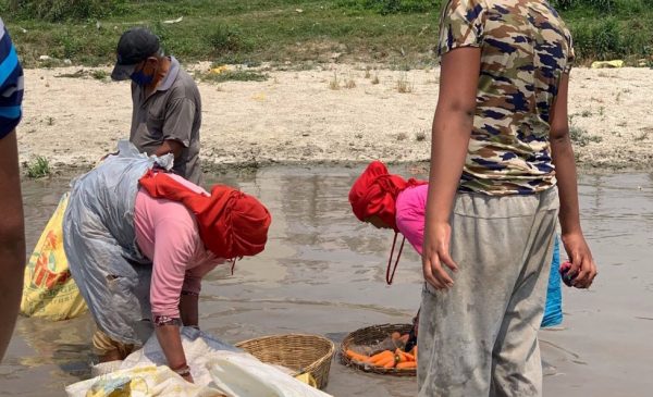 Residents of Kathmandu wash vegetables in raw river water.