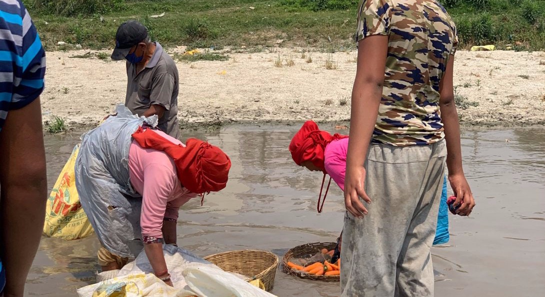 Residents of Kathmandu wash vegetables in raw river water.