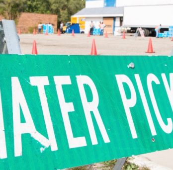 A sign denotes an area for drinking water pick up during a water crisis. 